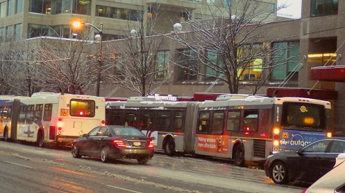 A live B-line bus passes a dead B-line eastbound at 8 a.m. Westbound almost mo buses were moving.